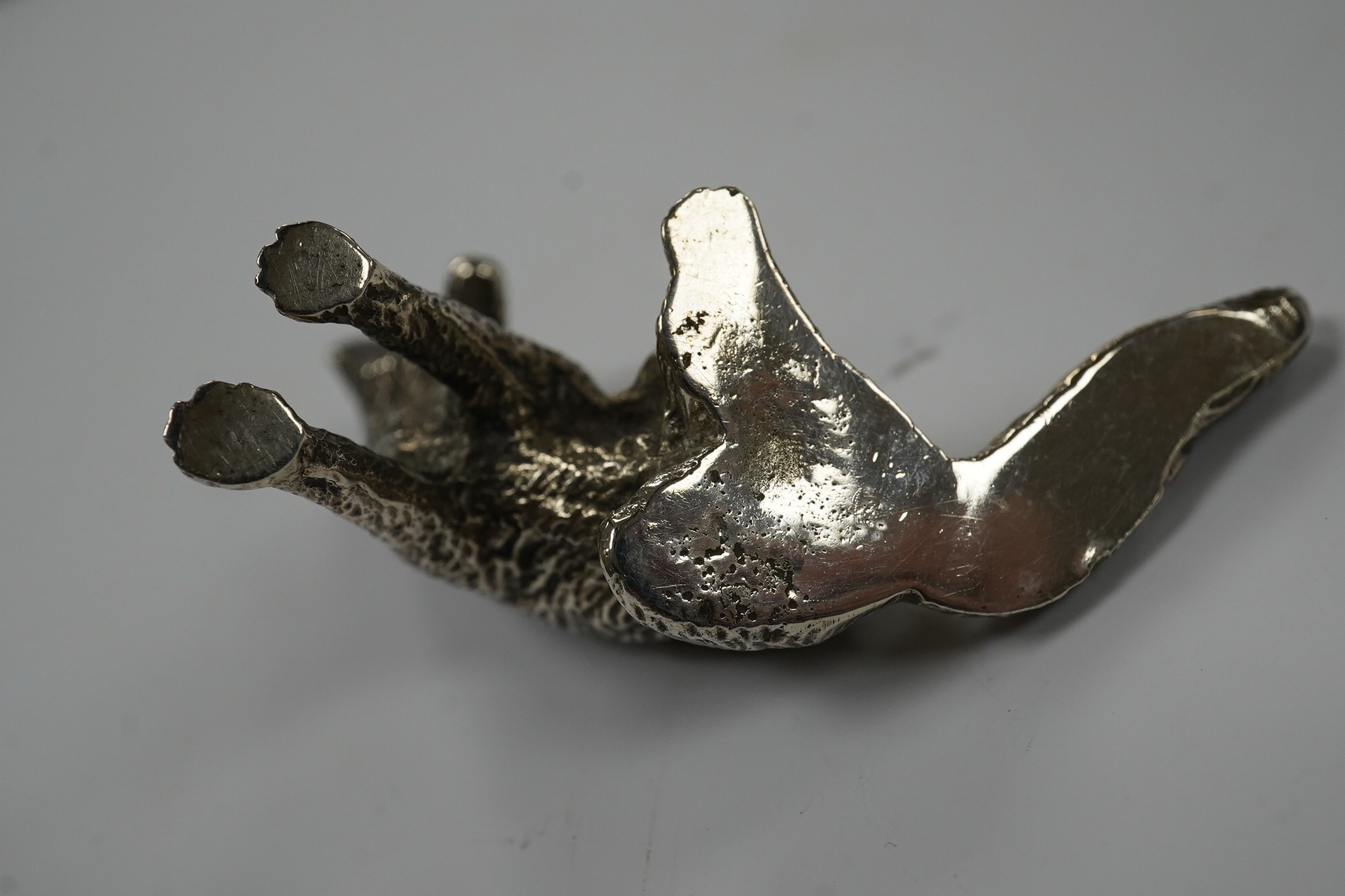 Two 1960's silver miniature models of a fox, both London, 1968, seated by Edward Barnard & Sons Ltd, height 38mm and one other smaller silver model of a running fox, 6.7oz. Condition - fair to good